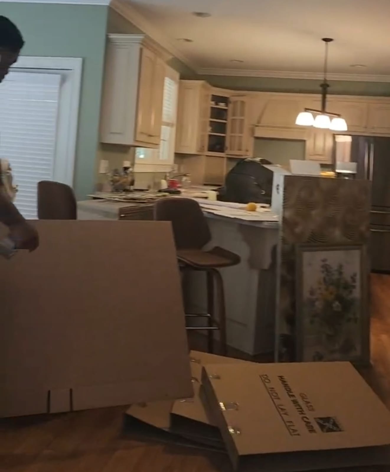Kitchen with moving boxes and household items during a transition
